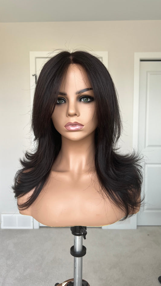 A long, dark brown human hair lace front glueless medical wig with soft waves and bangs displayed front view. Based in Winnipeg, Manitoba, Canada.